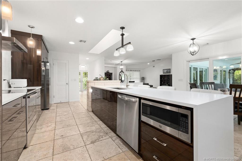 40 North River Road Stuart, FL 34996 - Photo 15 of 51 a kitchen with a sink and cabinets