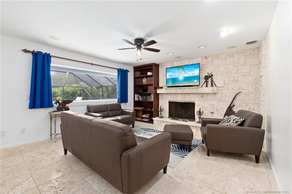 40 North River Road Stuart, FL 34996 - Photo 17 of 51 a living room with furniture a fireplace and a flat screen tv
