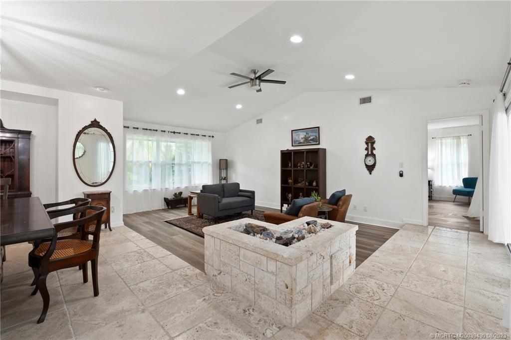 40 North River Road Stuart, FL 34996 - Photo 20 of 51 a living room with furniture a large window and a mirror