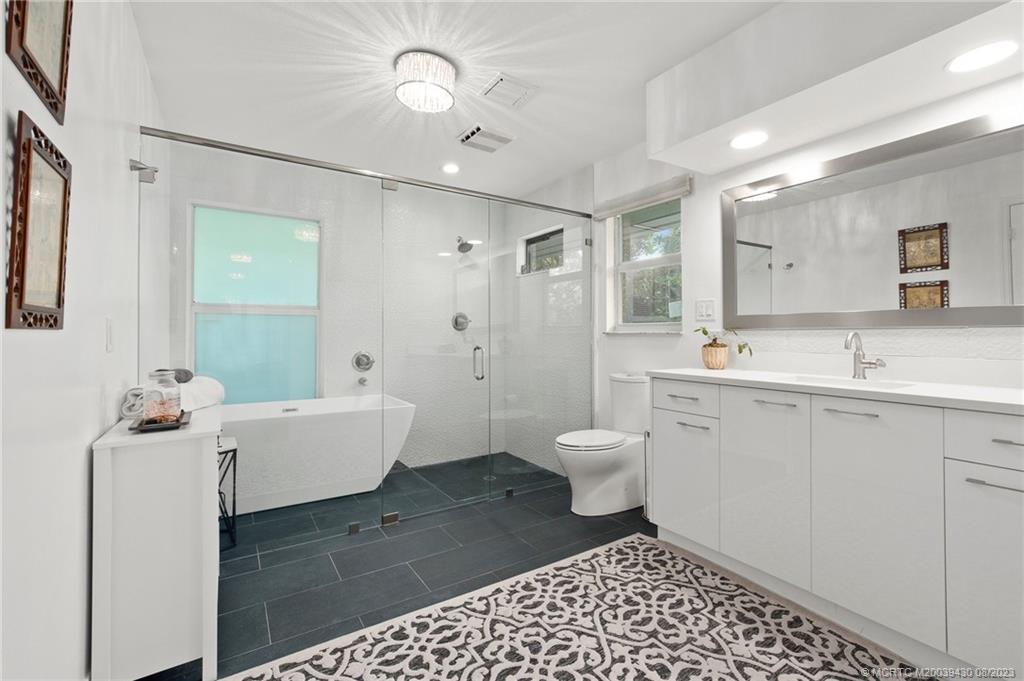 40 North River Road Stuart, FL 34996 - Photo 25 of 51 a spacious bathroom with a double vanity sink mirror and toilet