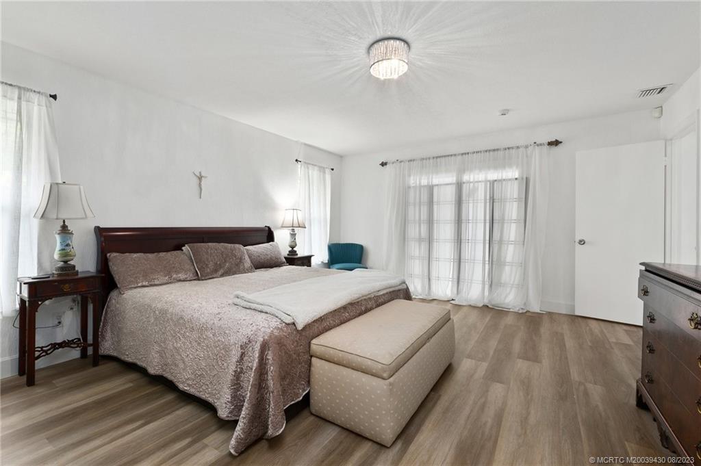 40 North River Road Stuart, FL 34996 - Photo 27 of 51 a spacious bedroom with a bed and a dresser