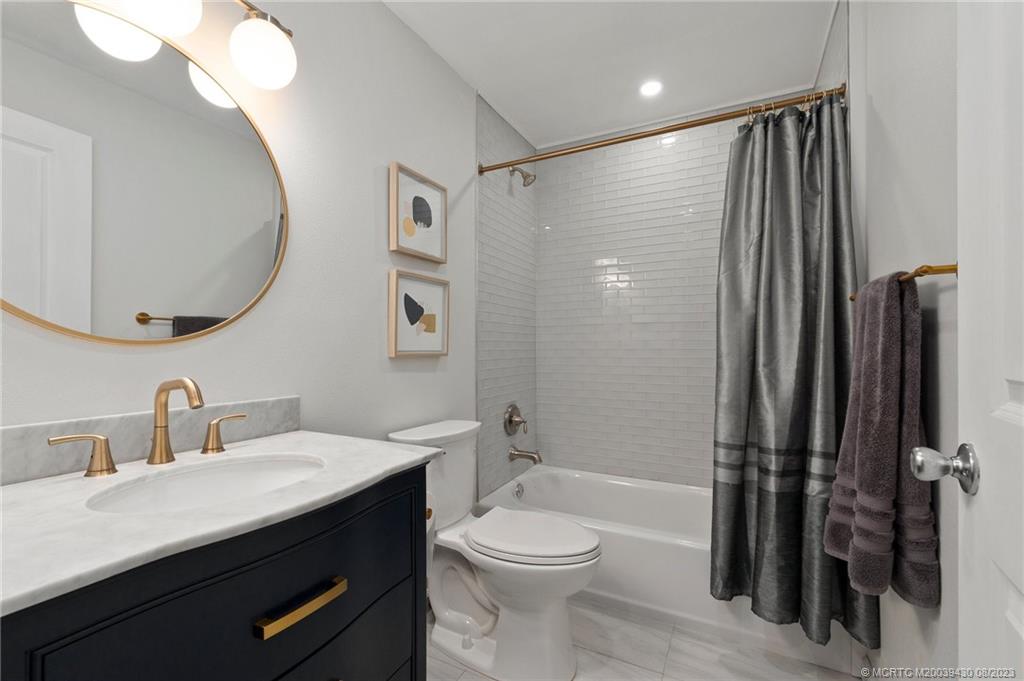 40 North River Road Stuart, FL 34996 - Photo 30 of 51 a bathroom with a sink a toilet and shower