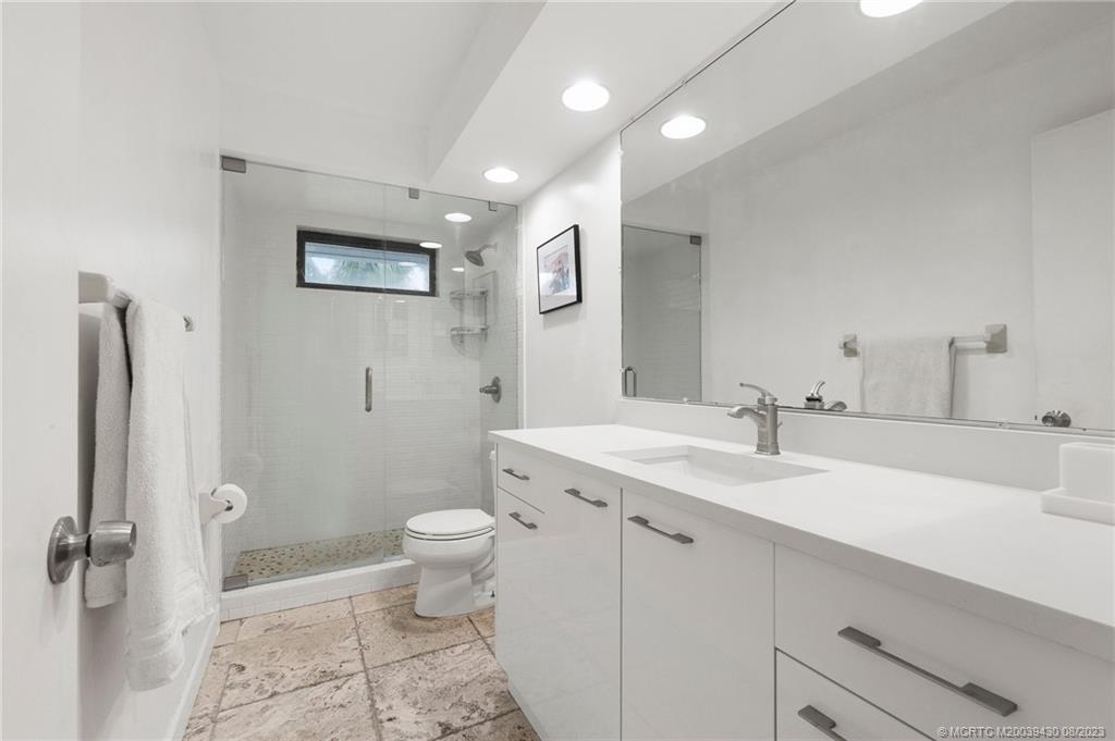 40 North River Road Stuart, FL 34996 - Photo 33 of 51 a bathroom with a sink toilet and a mirror
