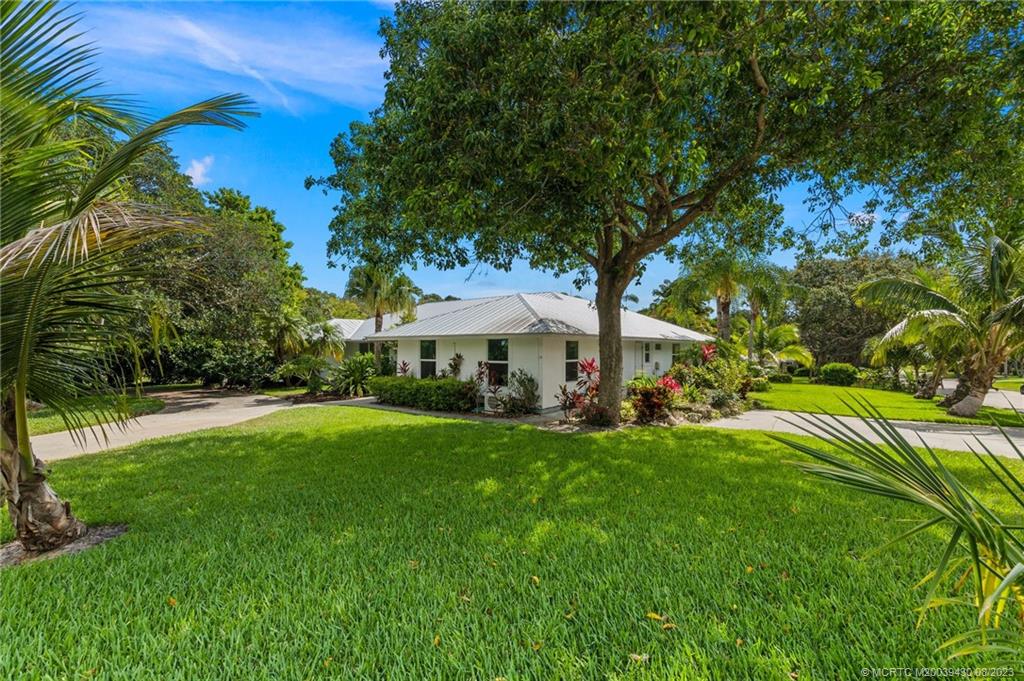 40 North River Road Stuart, FL 34996 - Photo 46 of 51 a view of a house with a big yard and large trees
