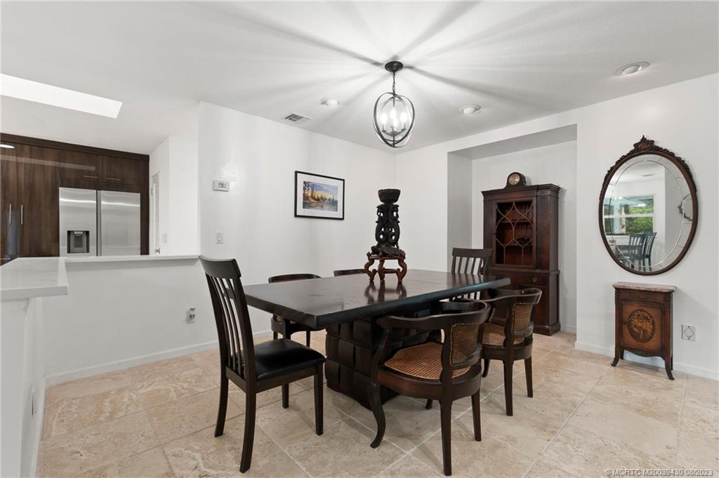 40 North River Road Stuart, FL 34996 - Photo 9 of 51 a view of a dining room with furniture and a chandelier