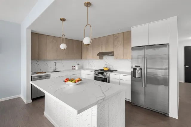 a kitchen that has a lot of cabinets a sink and a stove in it