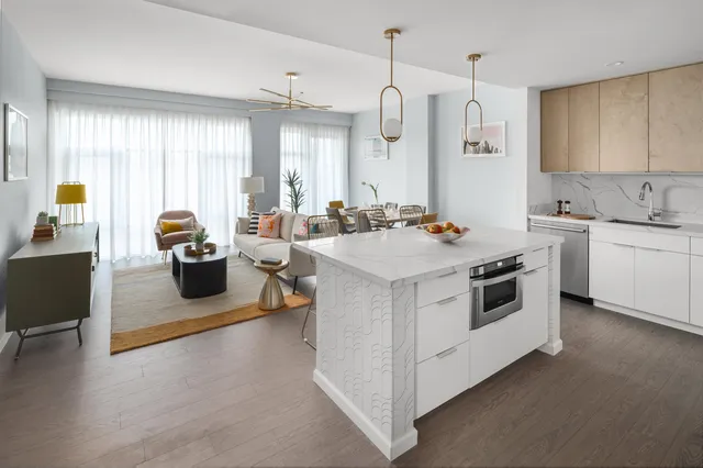 a kitchen with a stove a sink a refrigerator and windows