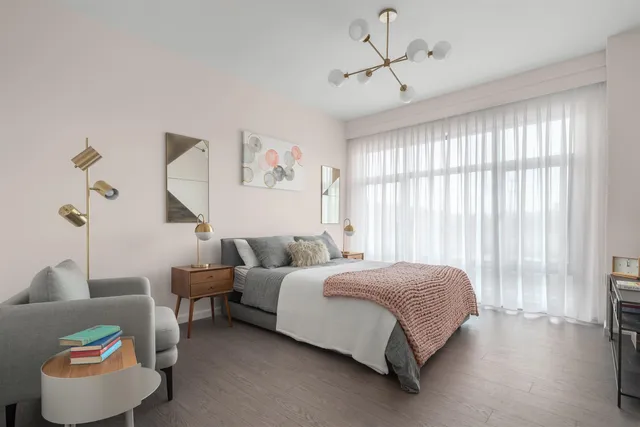 a spacious bedroom with a bed and a couch