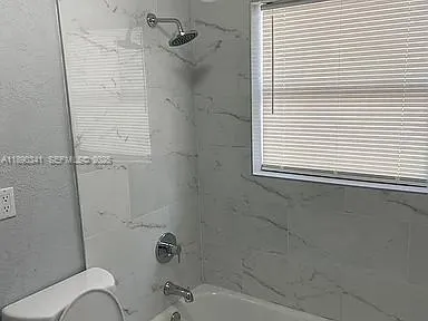 a bathroom with a sink a toilet and bathtub