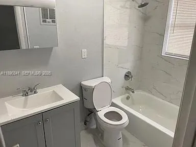 a bathroom with a sink mirror toilet and washer