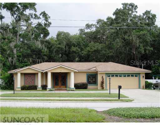 1423 Tampa Road Palm Harbor, FL 34683 - Photo 1 of 1 a front view of a house with a yard