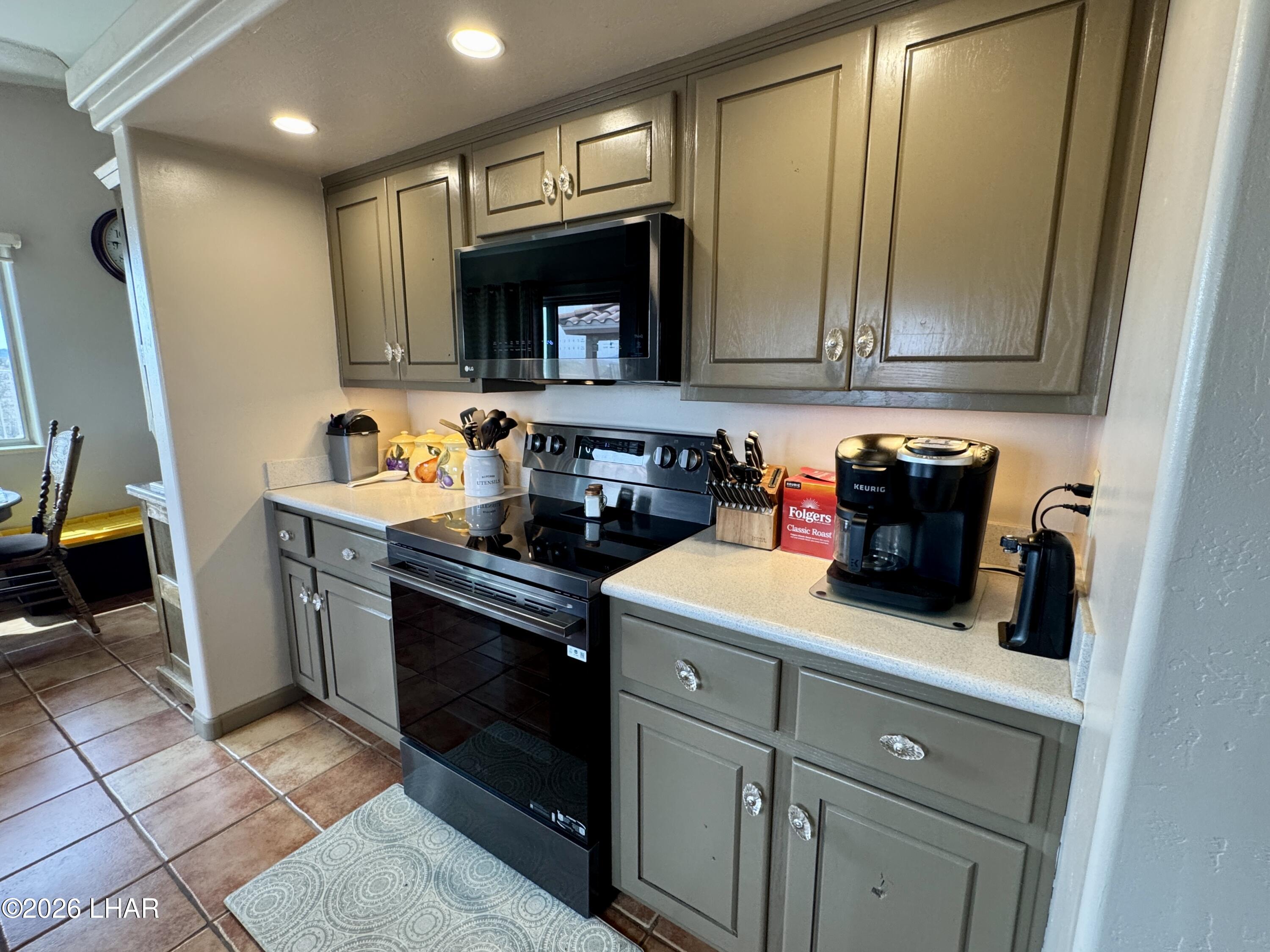 42832 La Posa Road Bouse, AZ 85325 - Photo 11 of 62 a kitchen with stainless steel appliances granite countertop a sink stove and cabinets