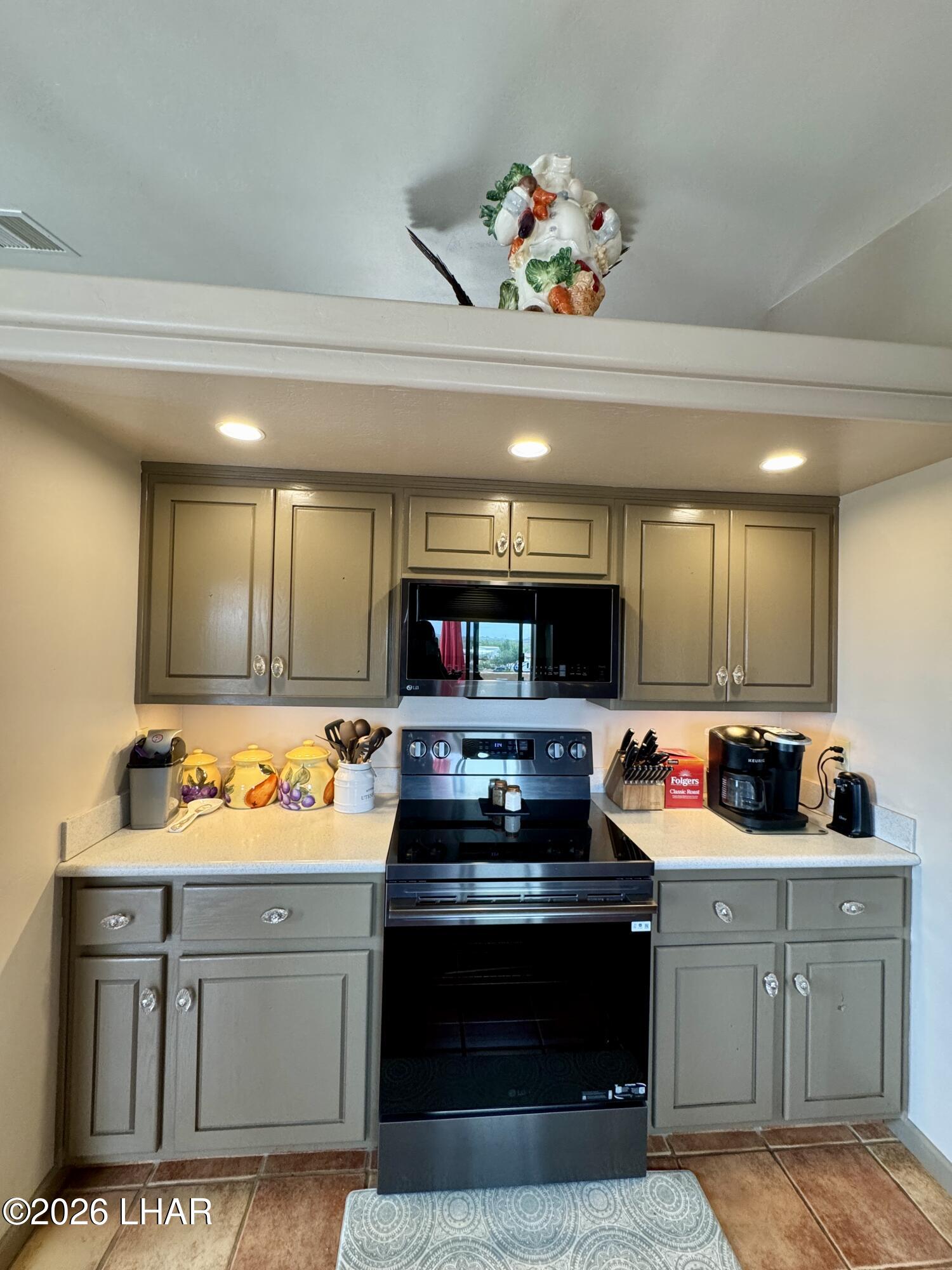 42832 La Posa Road Bouse, AZ 85325 - Photo 12 of 62 a kitchen with kitchen island stainless steel appliances a stove a sink and a microwave