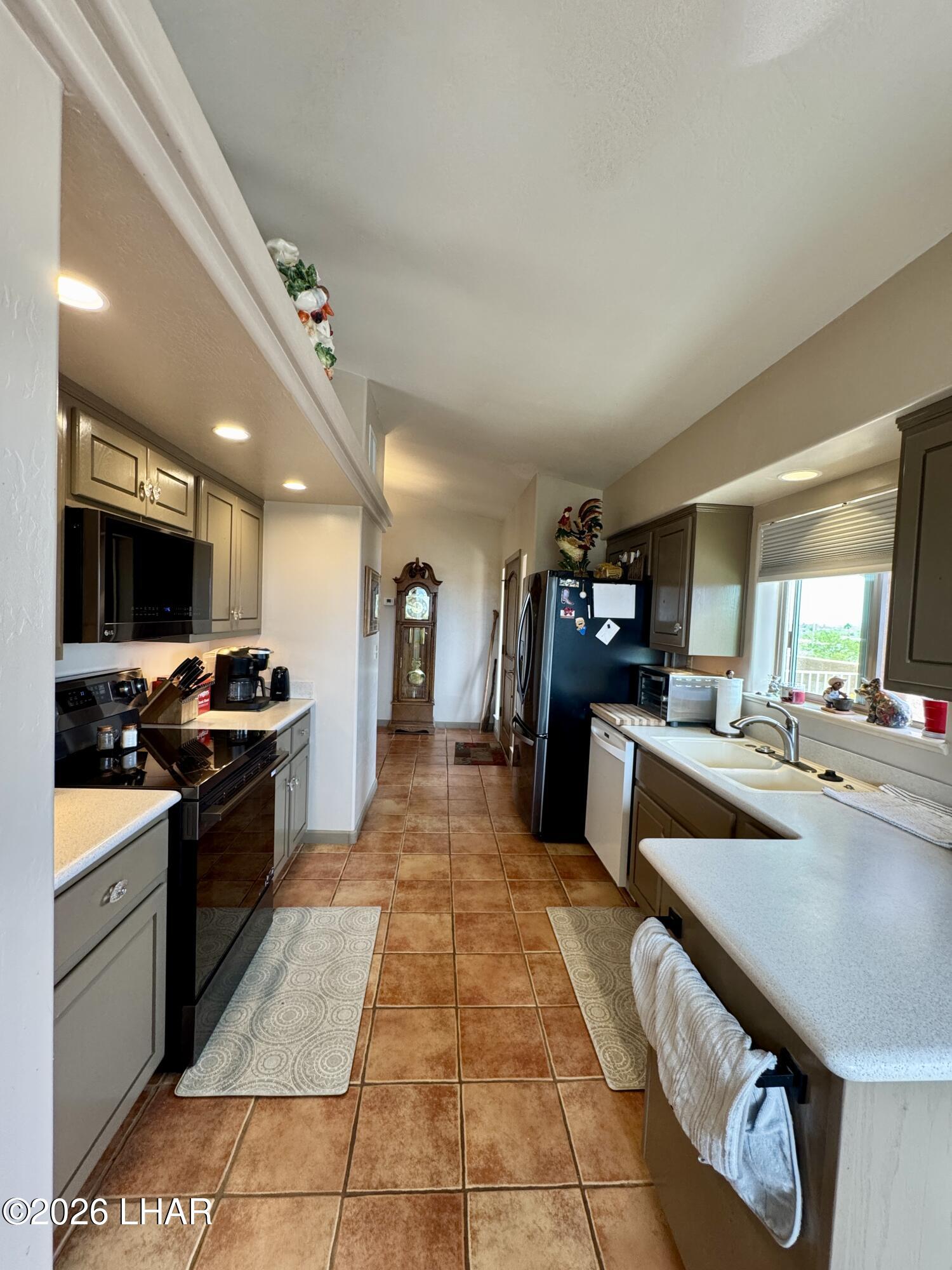 42832 La Posa Road Bouse, AZ 85325 - Photo 13 of 62 a large kitchen with a stove a sink and a refrigerator