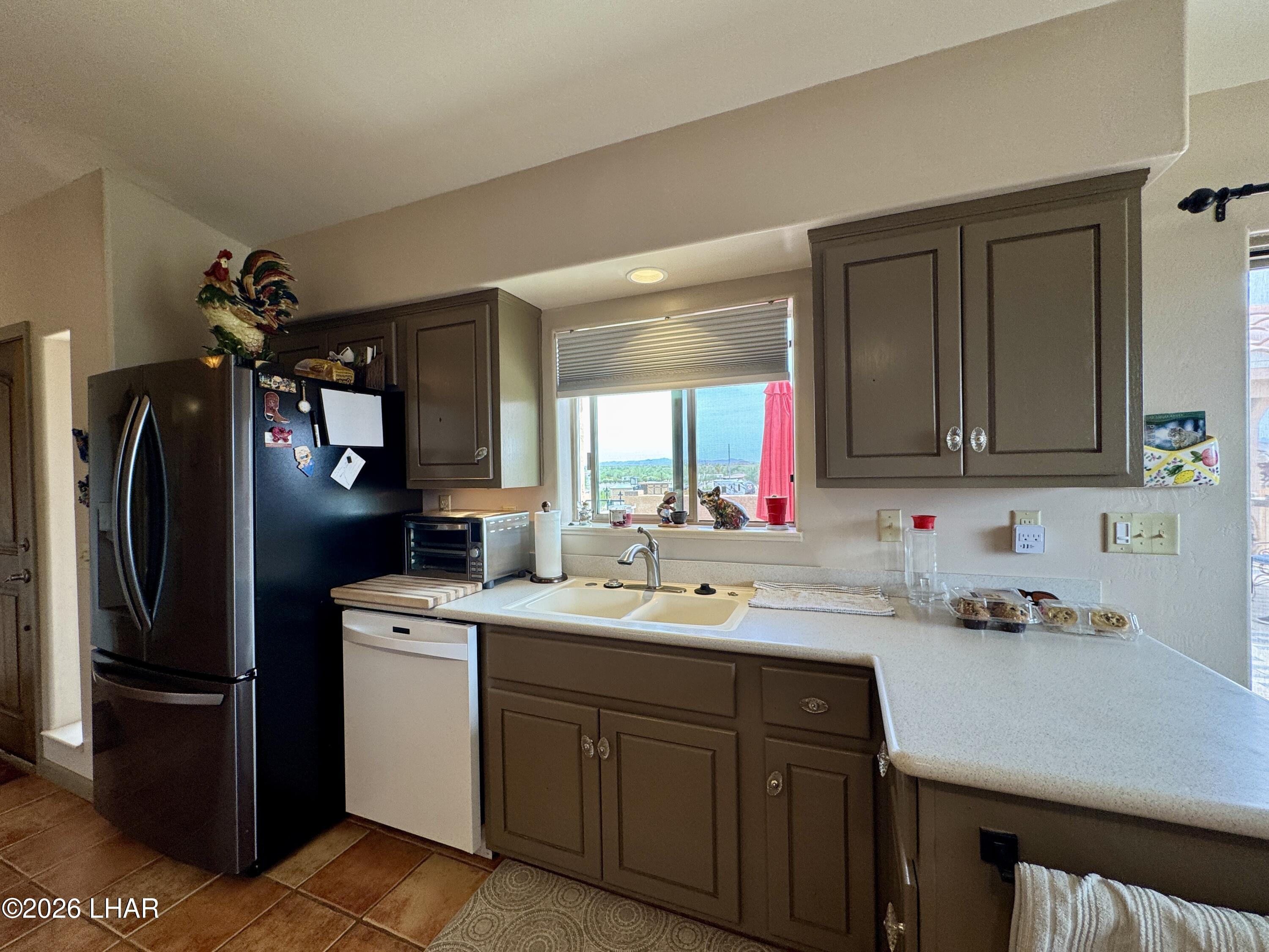 42832 La Posa Road Bouse, AZ 85325 - Photo 14 of 62 a kitchen with a sink cabinets and stainless steel appliances