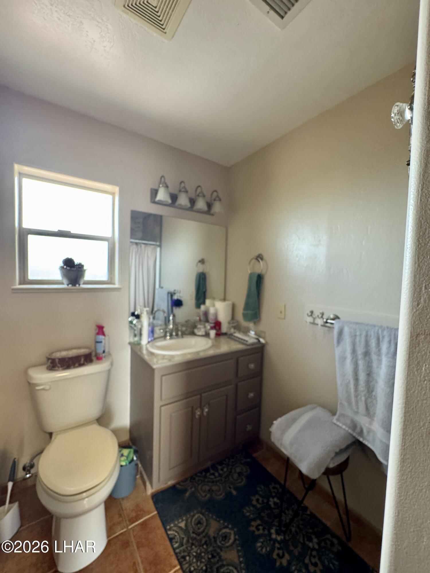 42832 La Posa Road Bouse, AZ 85325 - Photo 26 of 62 a view of bathroom with a toilet sink and mirror