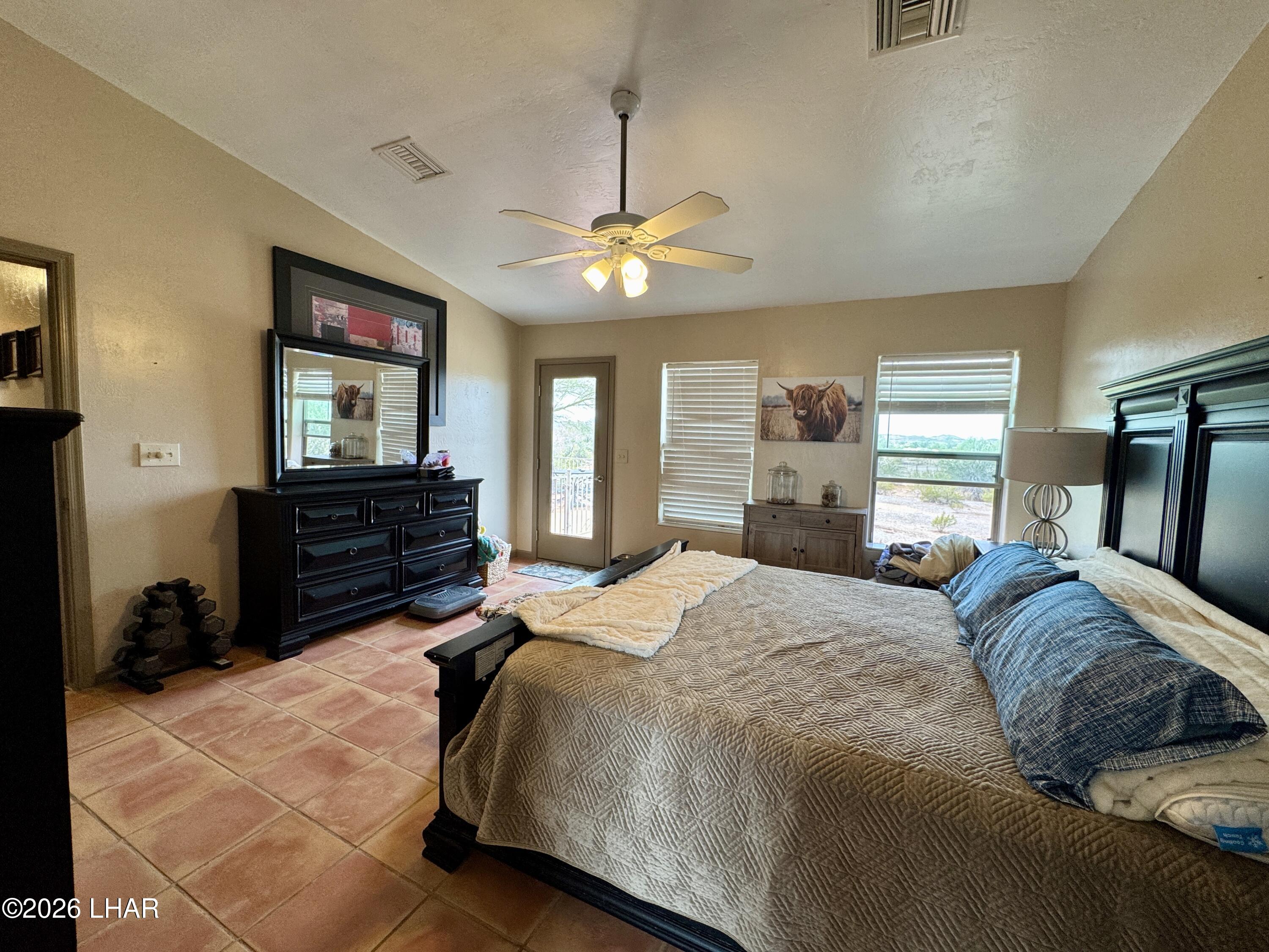 42832 La Posa Road Bouse, AZ 85325 - Photo 30 of 62 a spacious bedroom with a bed dresser and a window