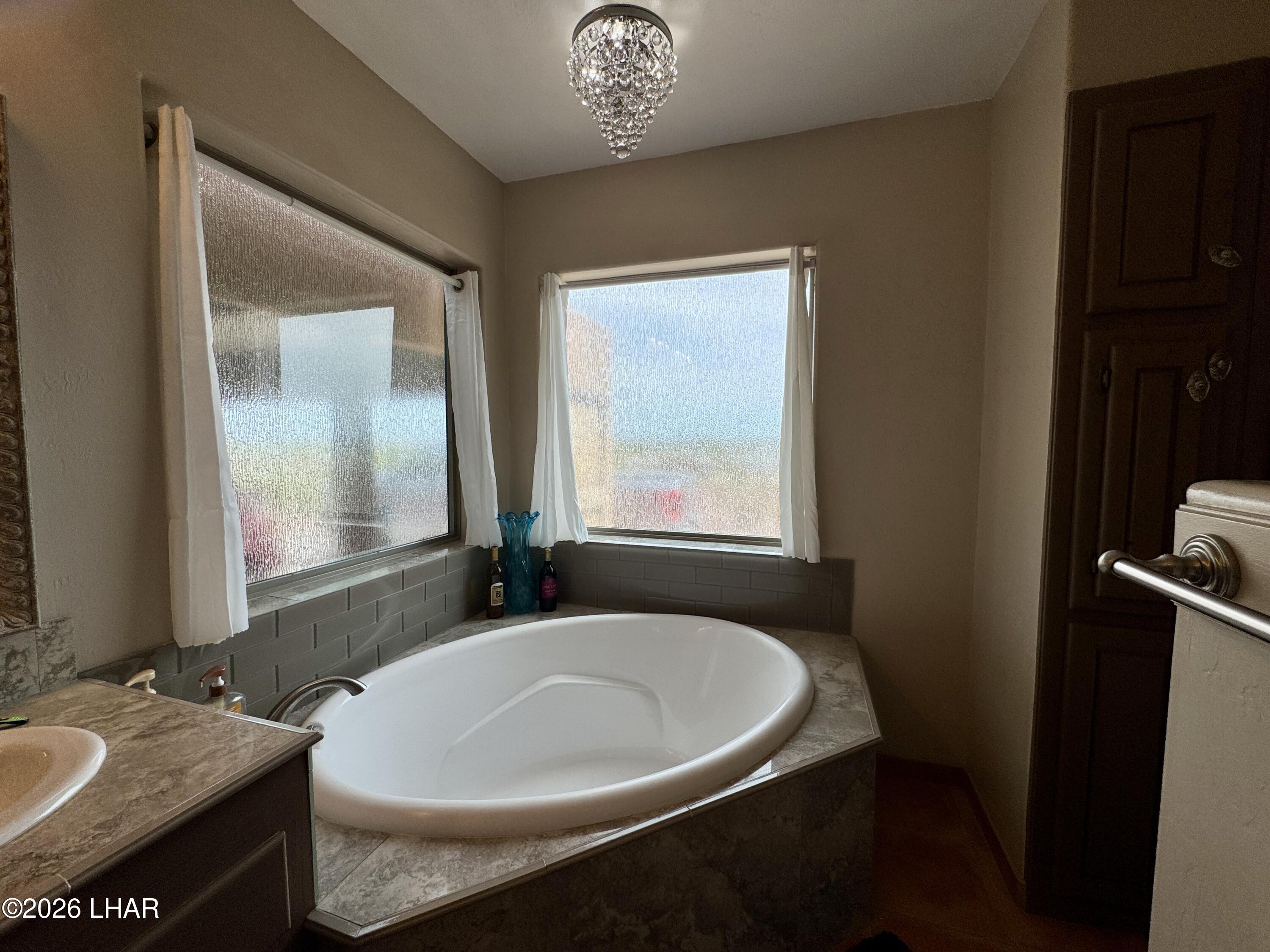42832 La Posa Road Bouse, AZ 85325 - Photo 33 of 62 a bath room with a sink and a mirror