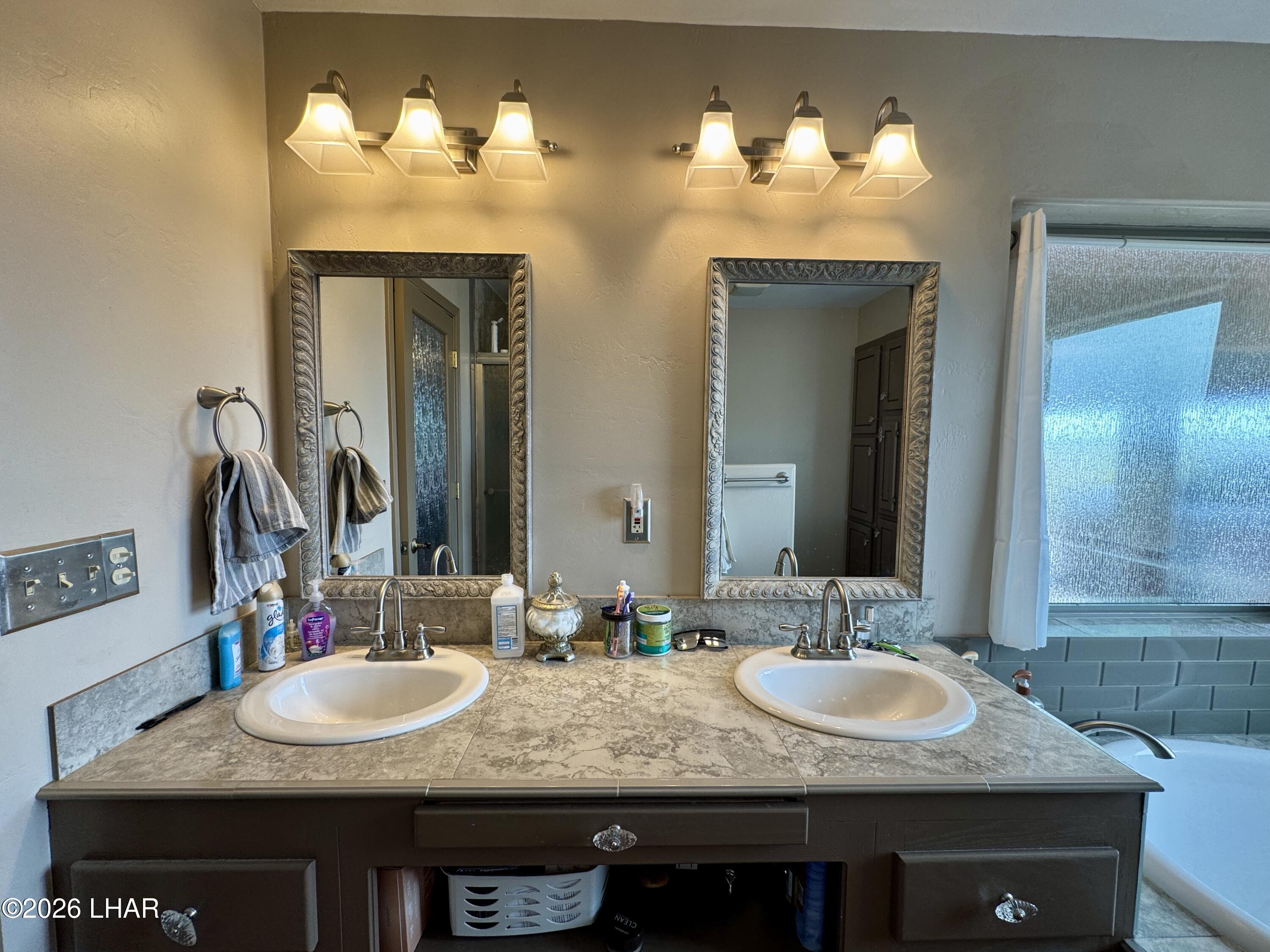 42832 La Posa Road Bouse, AZ 85325 - Photo 35 of 62 a bathroom with a granite countertop sink and a mirror