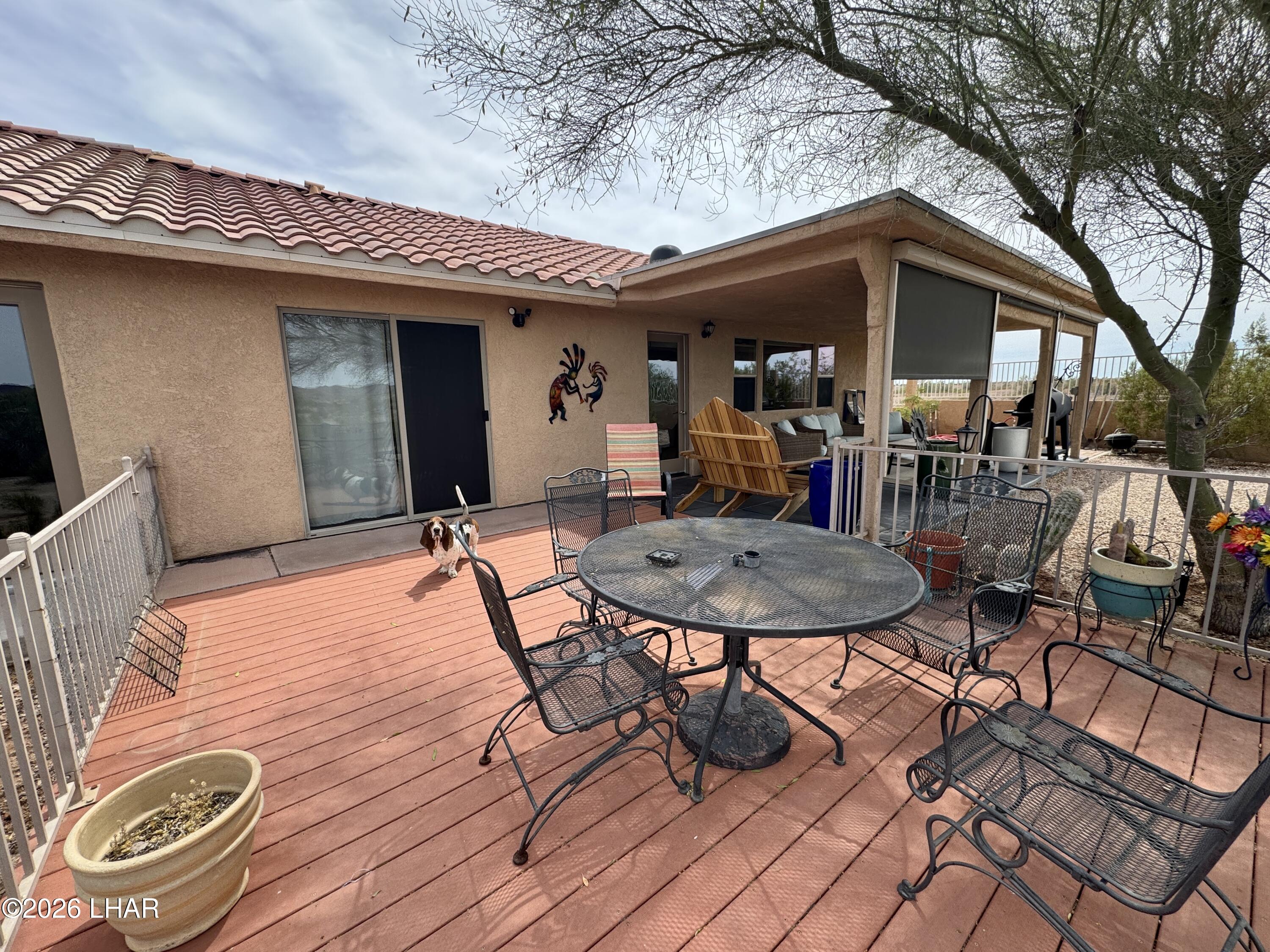42832 La Posa Road Bouse, AZ 85325 - Photo 39 of 62 a view of a patio with table and chairs under an umbrella with wooden floor