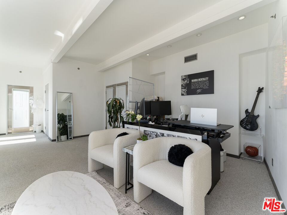 31518 Anacapa View Drive Malibu, CA 90265 - Photo 28 of 75 a living room with furniture a flat screen tv and a refrigerator