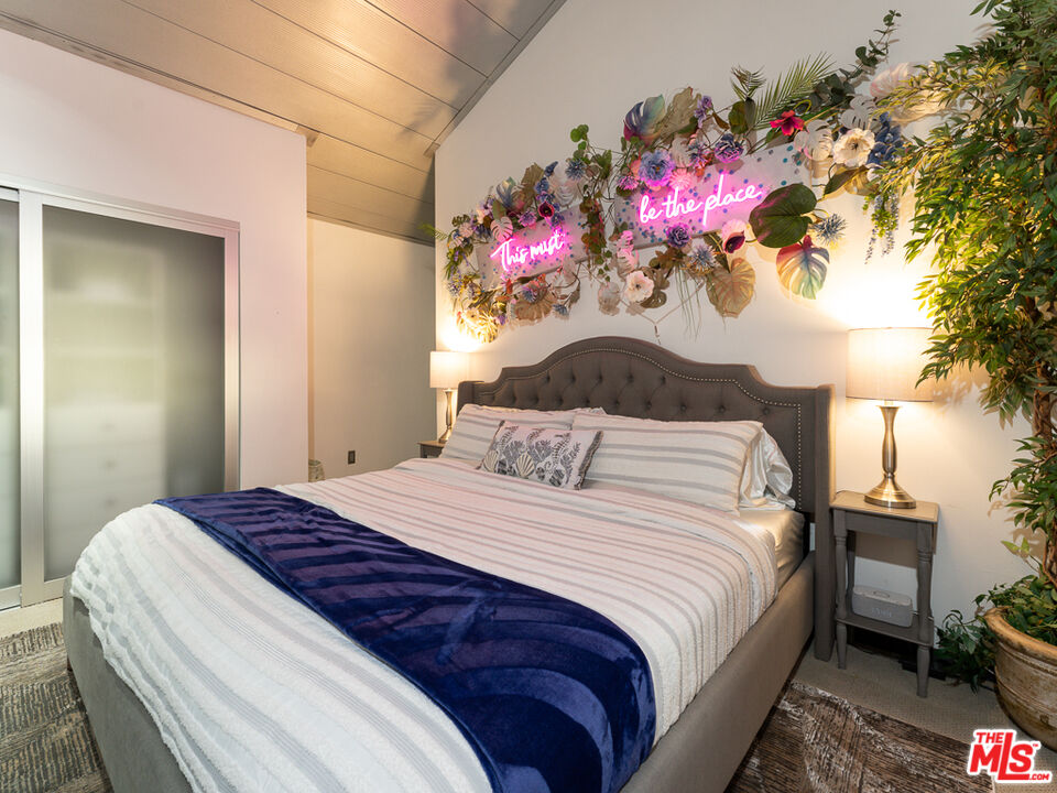 31518 Anacapa View Drive Malibu, CA 90265 - Photo 42 of 75 a bedroom with a bed and a chandelier