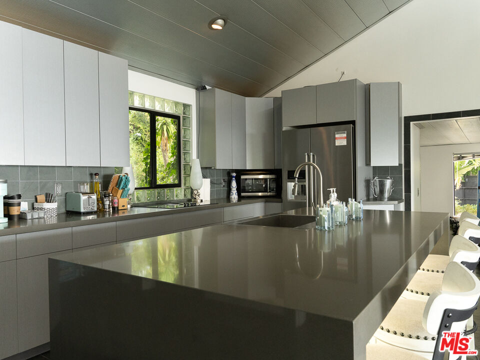 31518 Anacapa View Drive Malibu, CA 90265 - Photo 63 of 75 a kitchen with counter top space a sink and cabinets