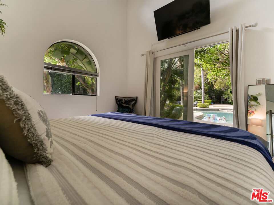 31518 Anacapa View Drive Malibu, CA 90265 - Photo 69 of 75 a bedroom with a bed and a window
