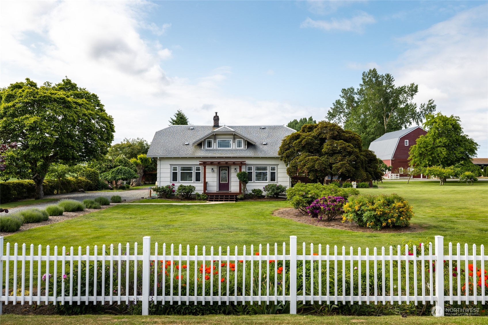 a front view of a house with a garden