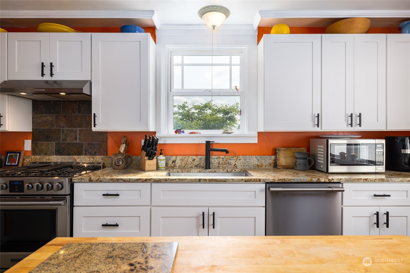 16244 Field Road Bow, WA 98232 - Photo 12 of 40 a kitchen with stainless steel appliances kitchen island granite countertop a sink stove and cabinets