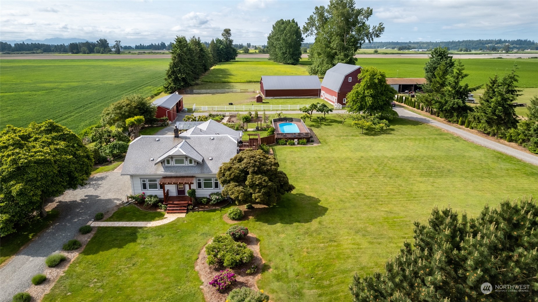 16244 Field Road Bow, WA 98232 - Photo 3 of 40 a aerial view of a house with swimming pool garden and lake view