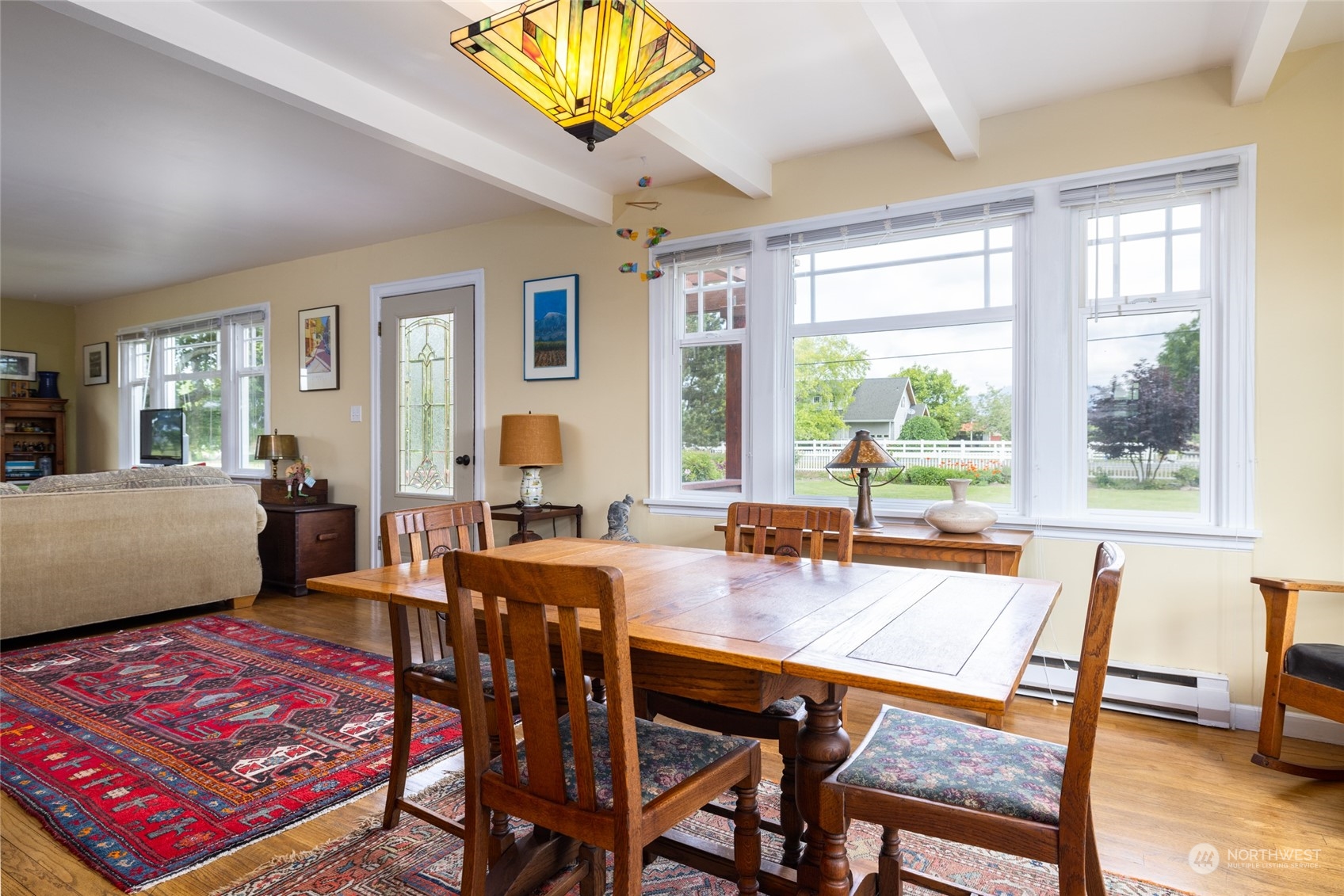 16244 Field Road Bow, WA 98232 - Photo 6 of 40 a dining room with furniture a rug and a potted plant