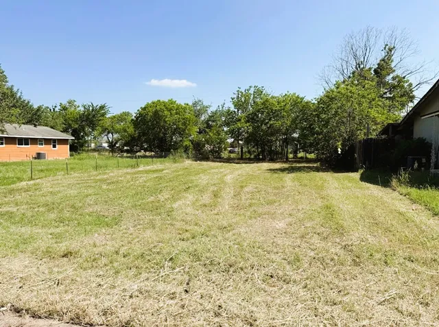 a swimming pool with trees in the background