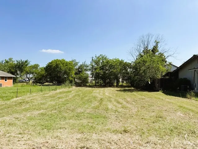 a yard with a trees in the background