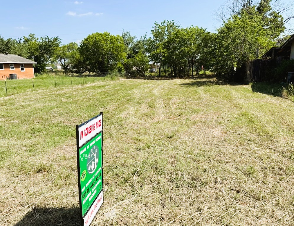 104 Burton Street Manor, TX 78653 - Photo 9 of 11 a sign board with yard in front of it