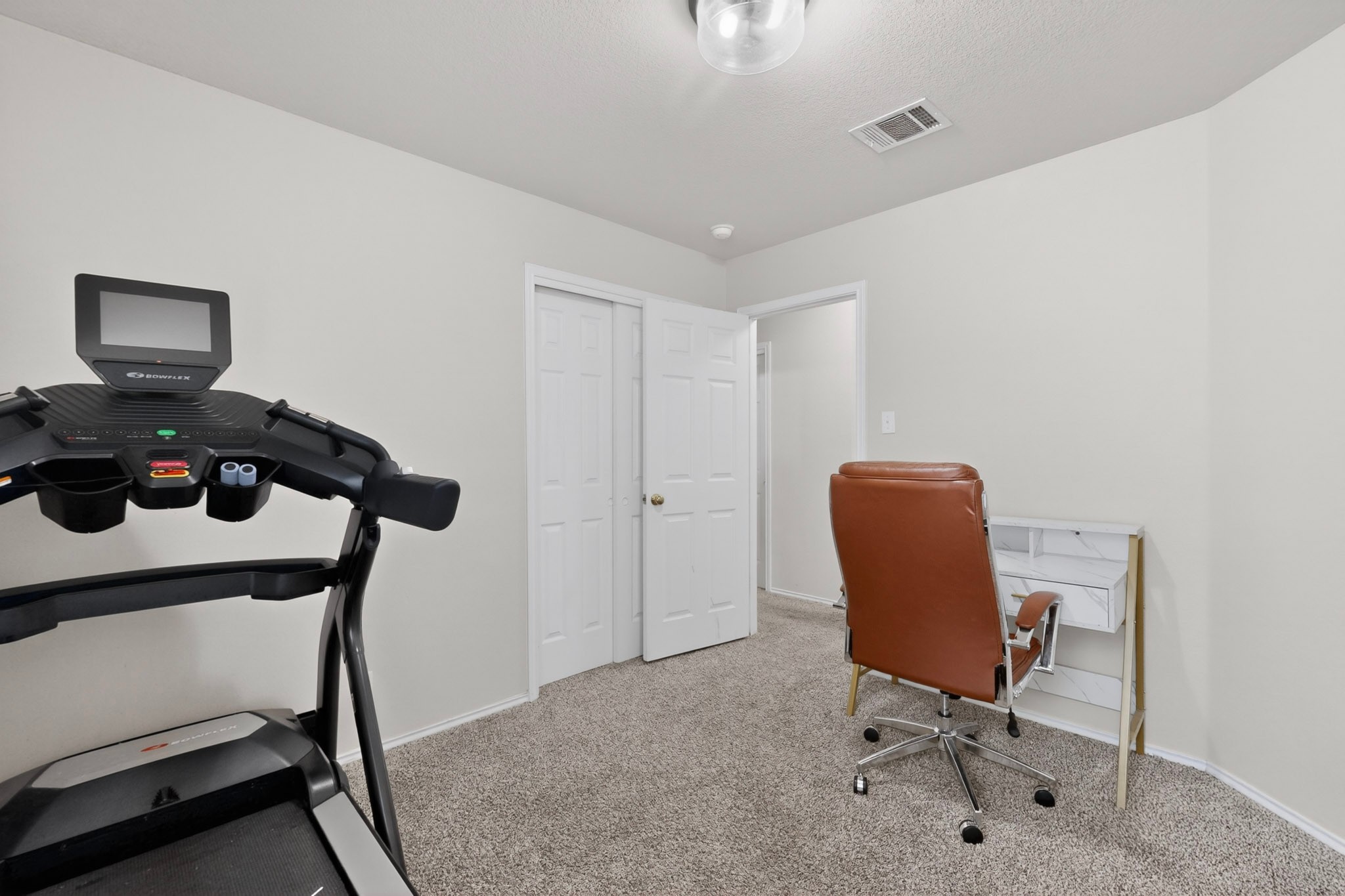 3906 Reeders Drive Austin, TX 78725 - Photo 30 of 36 Neutral-toned room with light gray wall paint and gray textured carpeting