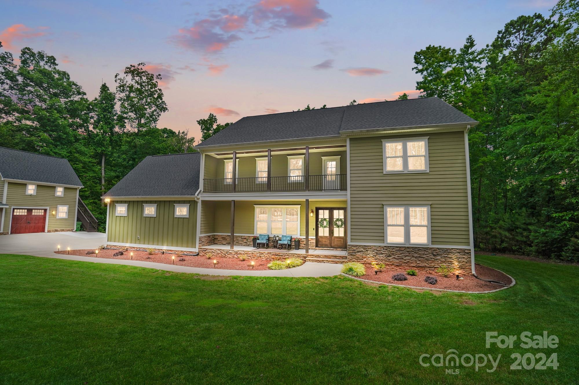 1123 Blacksnake Road Stanley, NC 28164 - Photo 1 of 48 a front view of a house with a yard table and chairs