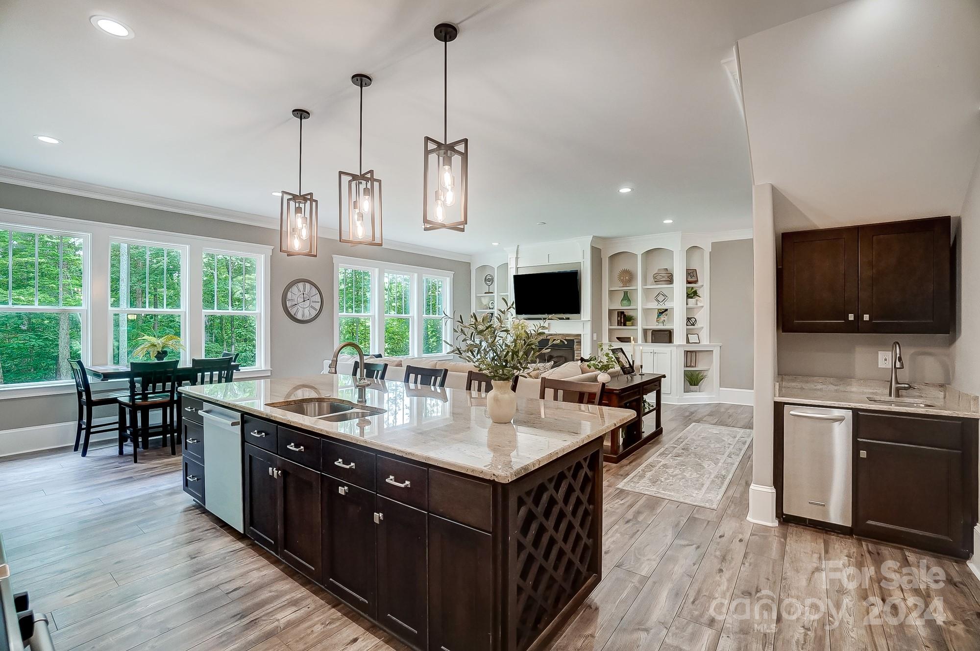 1123 Blacksnake Road Stanley, NC 28164 - Photo 12 of 48 a large kitchen with kitchen island granite countertop a large center island and a wooden floor