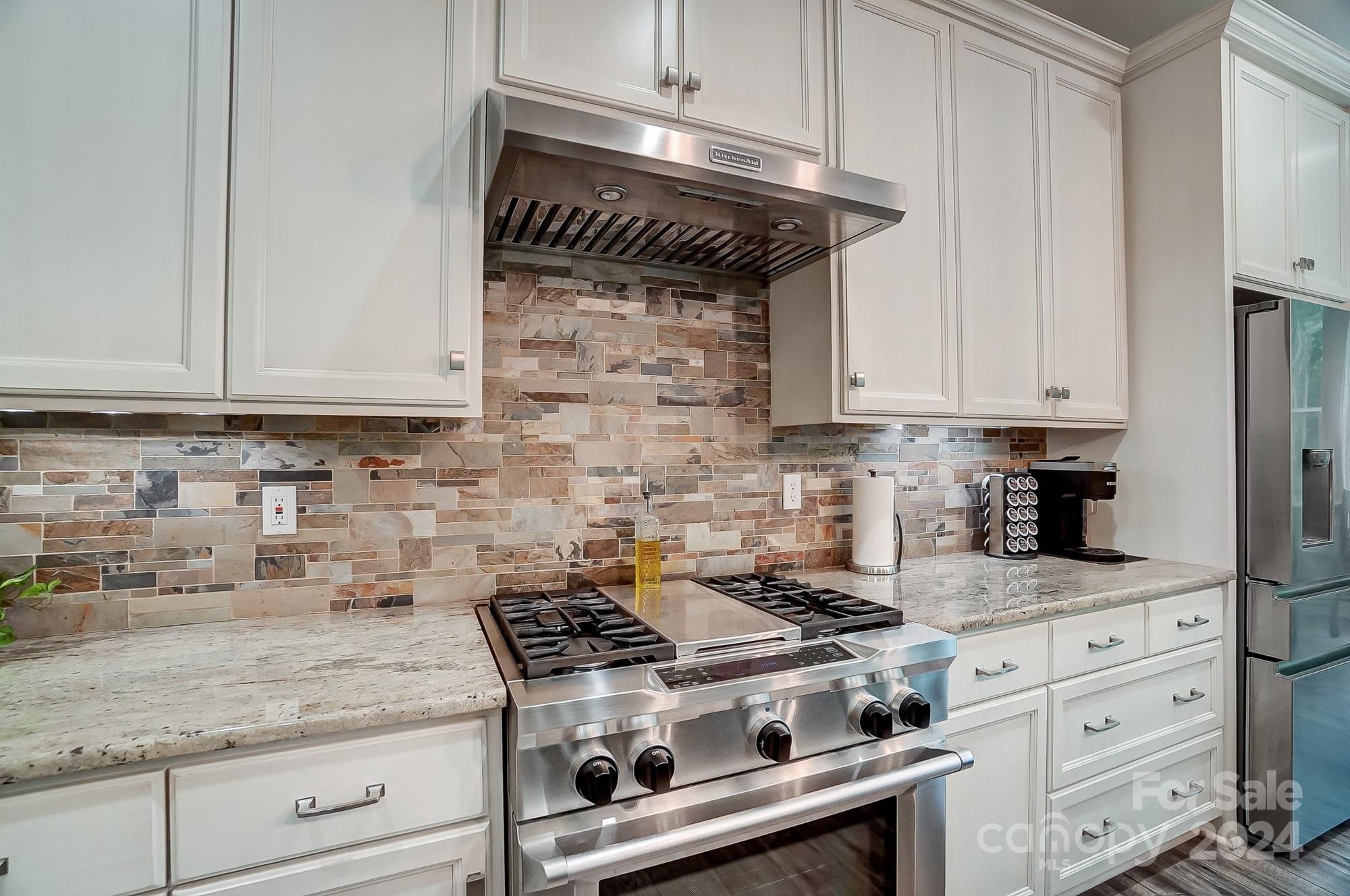 1123 Blacksnake Road Stanley, NC 28164 - Photo 13 of 48 a stove top oven sitting inside of a kitchen