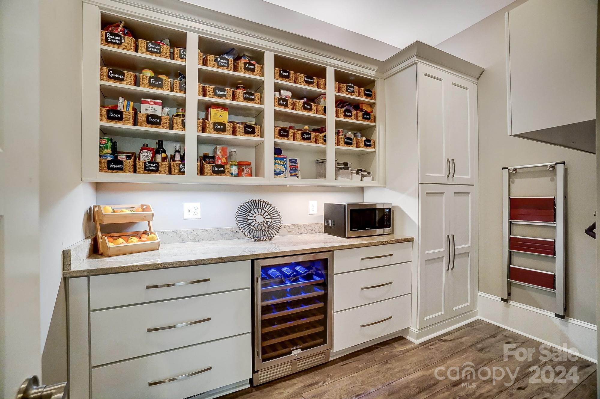1123 Blacksnake Road Stanley, NC 28164 - Photo 16 of 48 a kitchen with a cabinets and a wooden floor