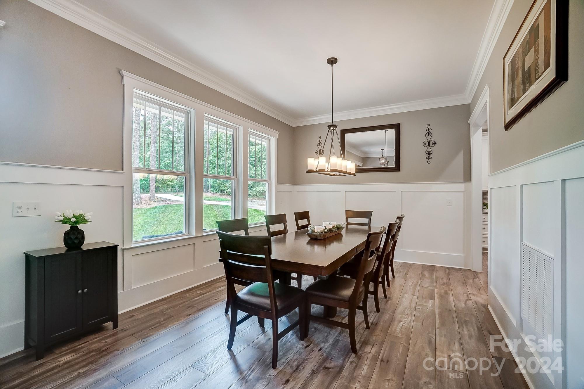 1123 Blacksnake Road Stanley, NC 28164 - Photo 17 of 48 a view of a dining room with furniture window and wooden floor