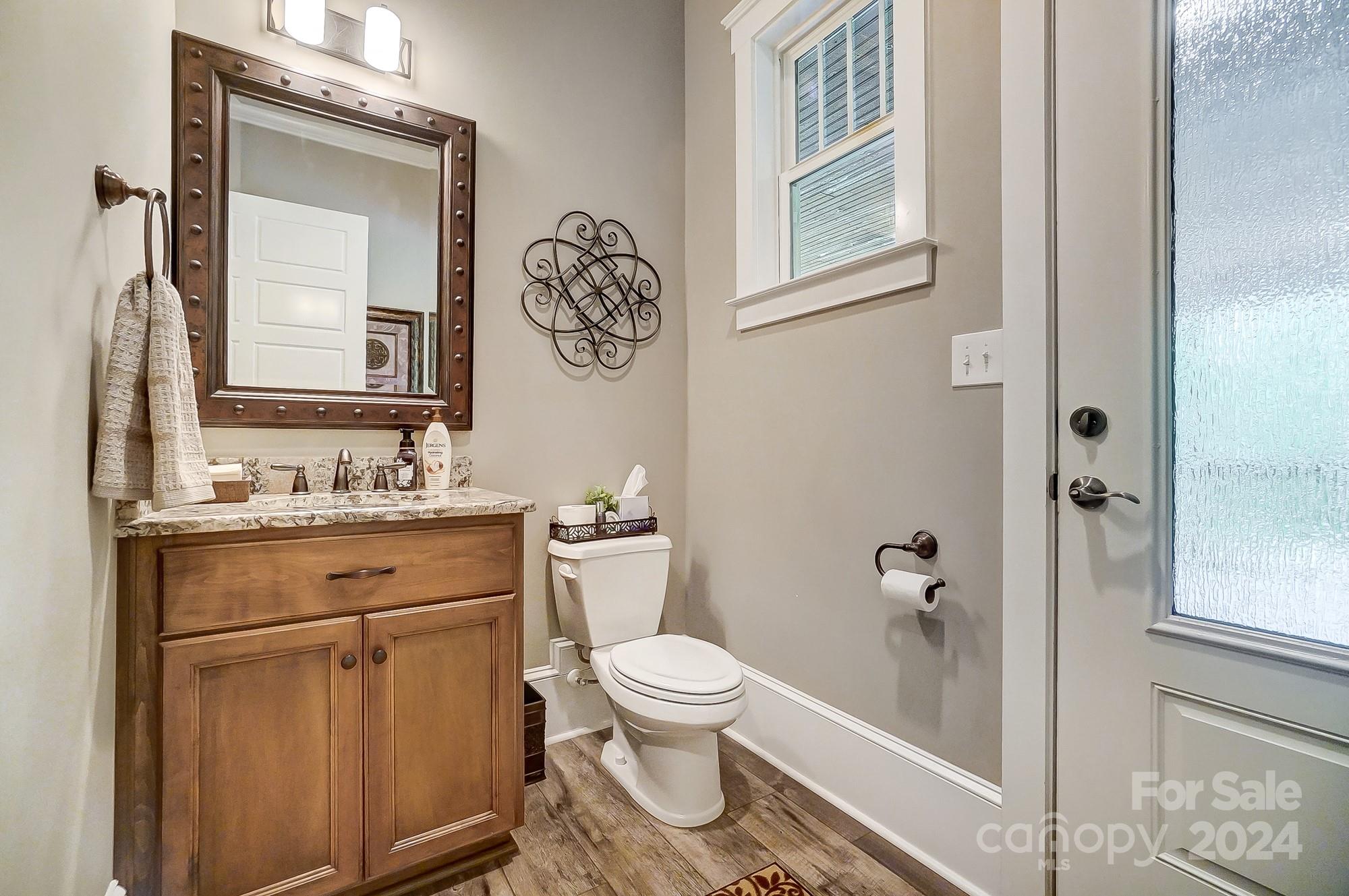 1123 Blacksnake Road Stanley, NC 28164 - Photo 18 of 48 a bathroom with a granite countertop toilet sink and mirror