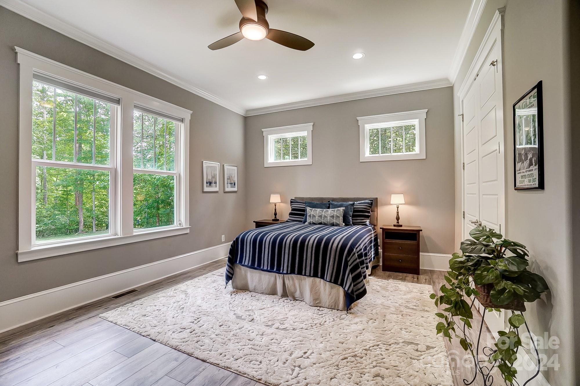 1123 Blacksnake Road Stanley, NC 28164 - Photo 19 of 48 a bedroom with a large bed and a chandelier