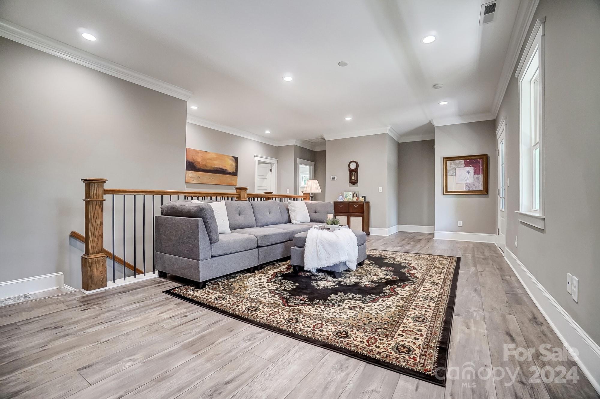 1123 Blacksnake Road Stanley, NC 28164 - Photo 23 of 48 a living room with furniture and a wooden floor