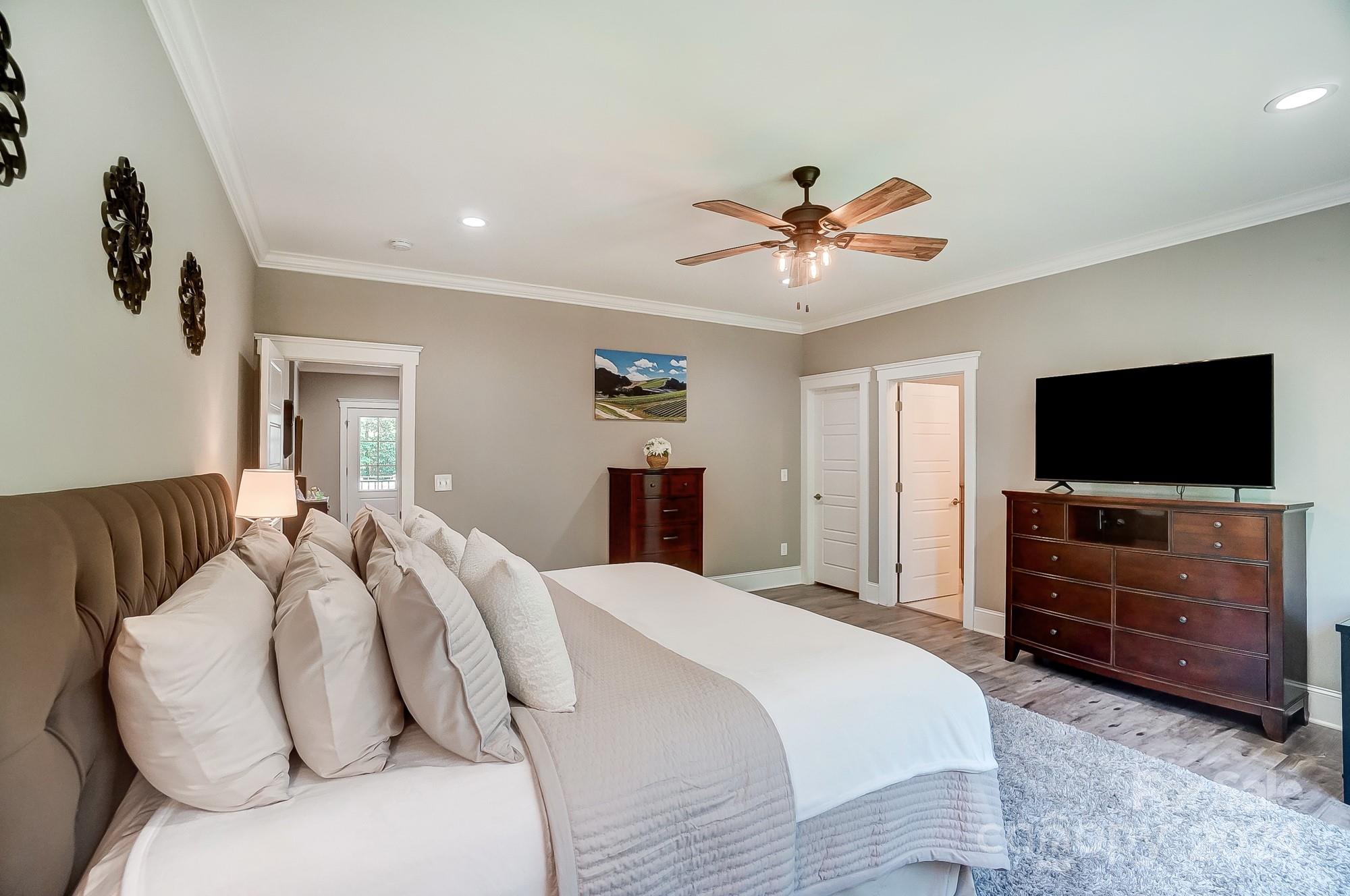 1123 Blacksnake Road Stanley, NC 28164 - Photo 25 of 48 a bedroom with a bed and a flat screen tv