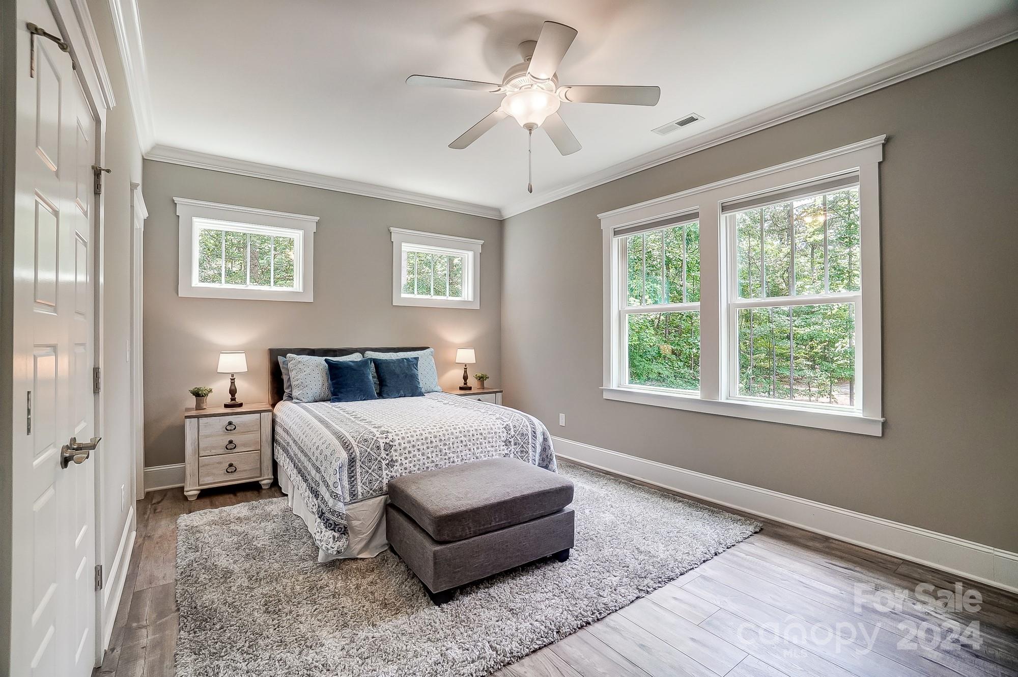 1123 Blacksnake Road Stanley, NC 28164 - Photo 32 of 48 a bedroom with a large bed chandelier and a window
