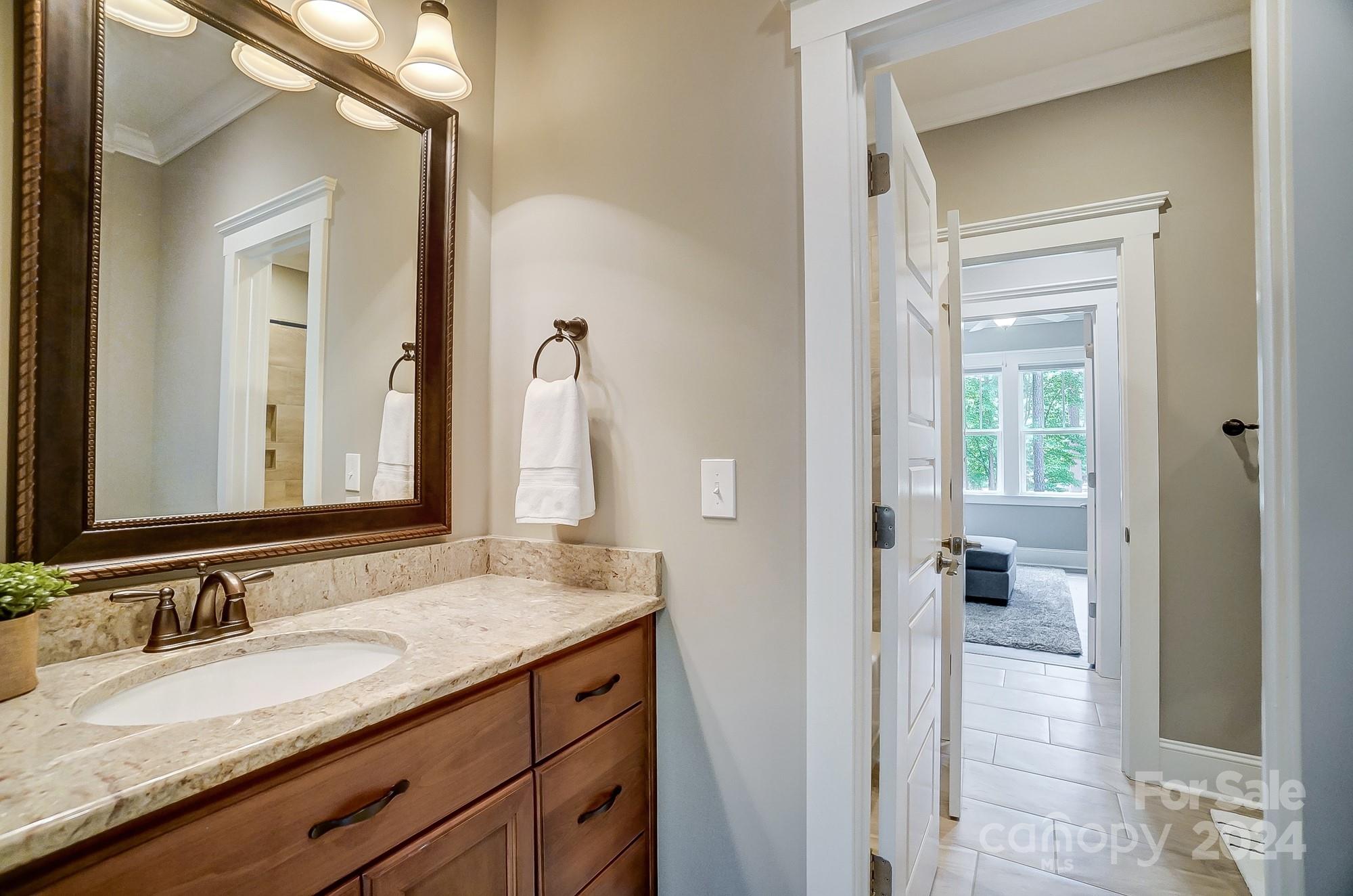 1123 Blacksnake Road Stanley, NC 28164 - Photo 36 of 48 a bathroom with a granite countertop sink and a mirror