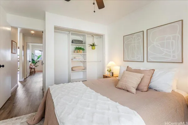 a bedroom with a bed and wooden floor