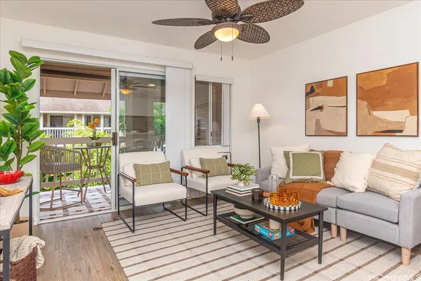 a living room with furniture and a floor to ceiling window