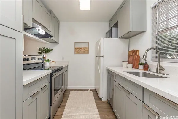 a kitchen with a sink cabinets and stainless steel appliances